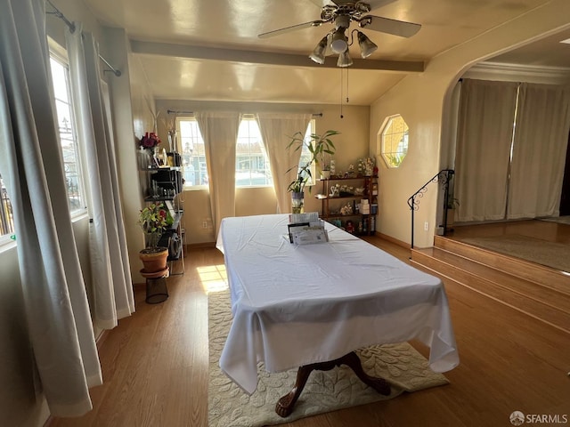 bedroom with arched walkways, pool table, light wood-style floors, and ceiling fan