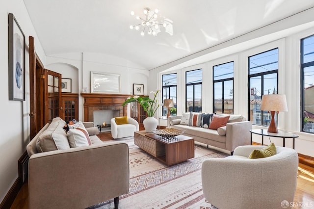 682 37th Ave, San Francisco, CA 94121 - living area with healthy amount of natural light, wood finished floors, lofted ceiling, a tiled fireplace, and a chandelier