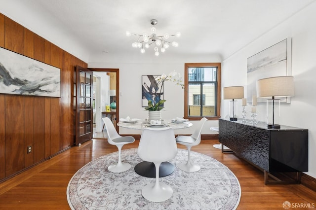 682 37th Ave, San Francisco, CA 94121 - dining space with dark wood-type flooring, a chandelier, and wooden walls