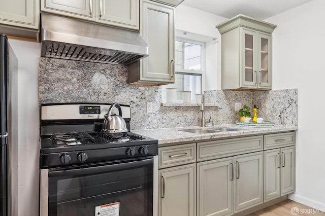 682 37th Ave, San Francisco, CA 94121 - kitchen featuring black gas range oven, under cabinet range hood, a sink, backsplash, and glass insert cabinets