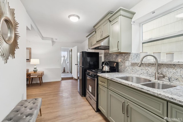 682 37th Ave, San Francisco, CA 94121 - kitchen featuring stainless steel range with gas stovetop, under cabinet range hood, a sink, tasteful backsplash, and healthy amount of natural light