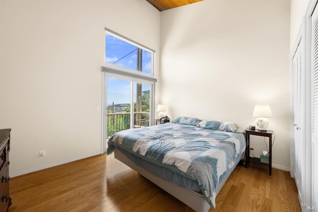66 Bridge Rd, Novato, CA 94945 - bedroom with a high ceiling, access to exterior, light wood-style flooring, and baseboards