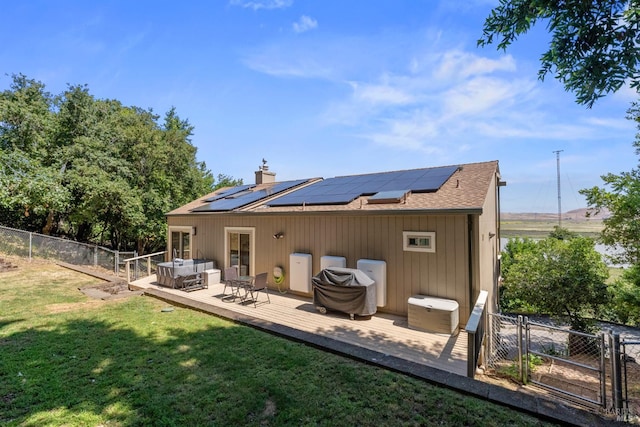 66 Bridge Rd, Novato, CA 94945 - back of house with a wooden deck, roof with shingles, and roof mounted solar panels