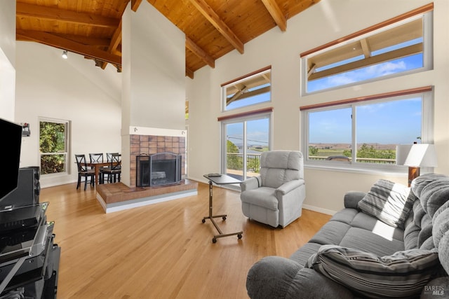 66 Bridge Rd, Novato, CA 94945 - living area featuring wood ceiling with exposed beams, wood finished floors, plenty of natural light, high vaulted ceiling, and baseboards