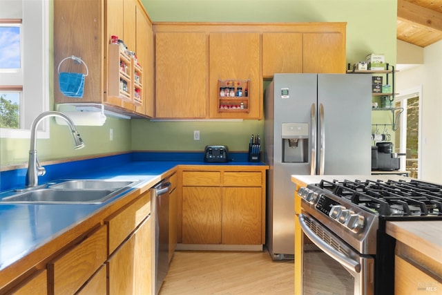 66 Bridge Rd, Novato, CA 94945 - kitchen with stainless steel appliances, a sink, light wood-style flooring, and vaulted ceiling