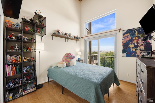 66 Bridge Rd, Novato, CA 94945 - bedroom featuring access to outside, wood finished floors, baseboards, and a towering ceiling