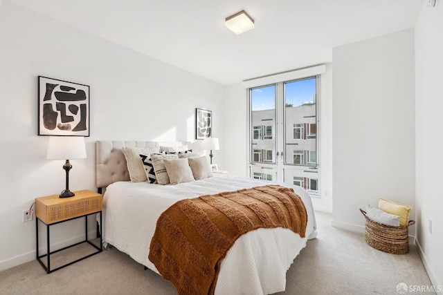 bedroom featuring light colored carpet