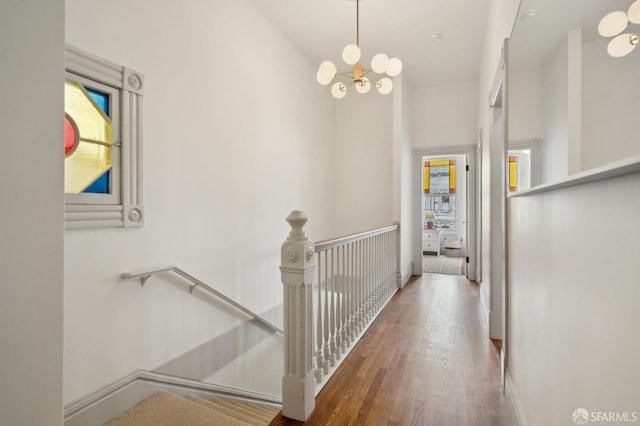 3511 23rd St Unit 1, San Francisco, CA 94110 - corridor featuring an upstairs landing, a chandelier, and wood finished floors