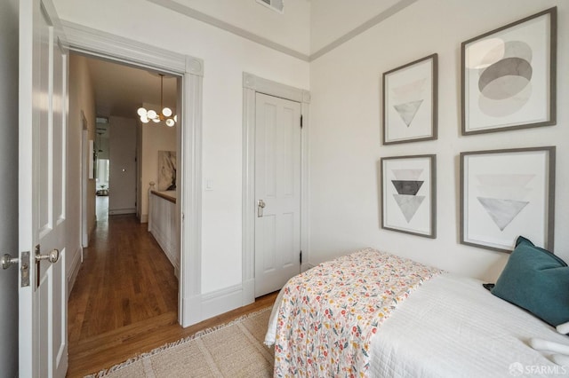 3511 23rd St Unit 1, San Francisco, CA 94110 - bedroom with a chandelier, wood finished floors, and a closet
