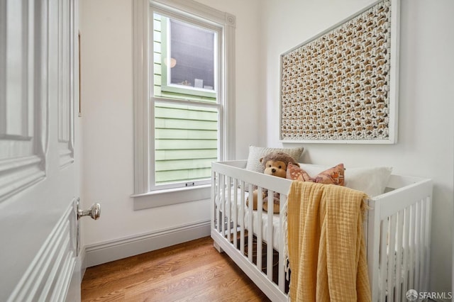 3511 23rd St Unit 1, San Francisco, CA 94110 - bedroom with a crib and wood finished floors