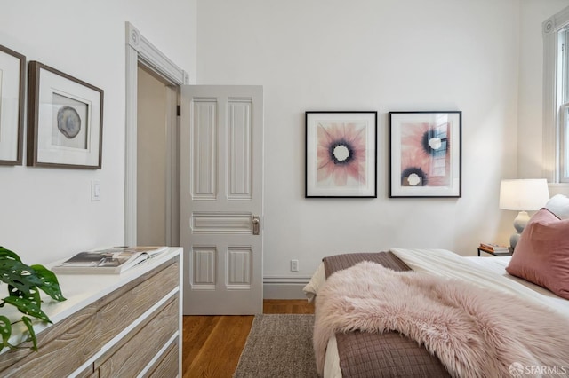 3511 23rd St Unit 1, San Francisco, CA 94110 - bedroom with dark wood-style floors and multiple windows