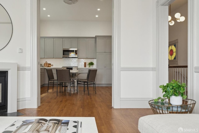 3511 23rd St Unit 1, San Francisco, CA 94110 - kitchen featuring stainless steel microwave, gray cabinetry, backsplash, dark wood-style floors, and recessed lighting