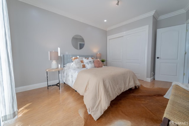 bedroom featuring crown molding, a closet, and light wood-type flooring