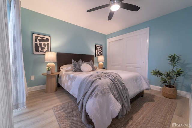 bedroom featuring a closet, ceiling fan, and light wood-type flooring