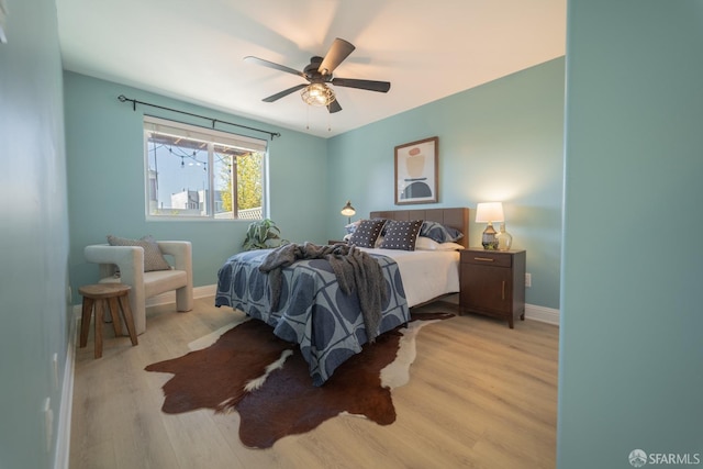 bedroom featuring light hardwood / wood-style flooring and ceiling fan