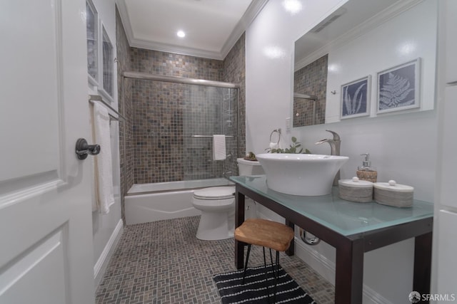 full bathroom with shower / bath combination with glass door, vanity, toilet, crown molding, and tile patterned floors