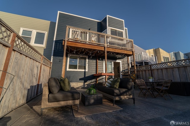 back of property with a balcony and a patio area