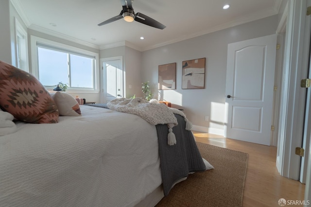 bedroom featuring crown molding, light hardwood / wood-style flooring, and ceiling fan