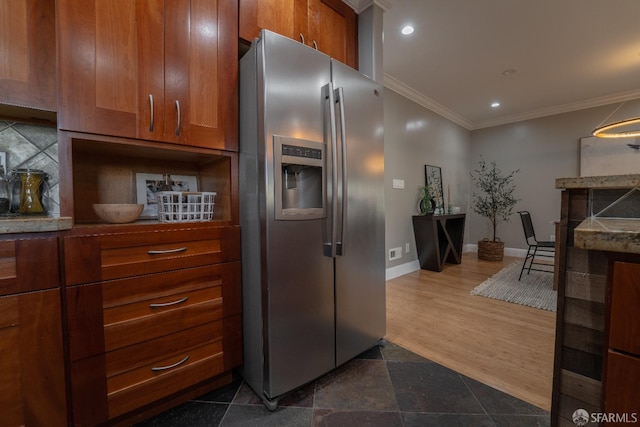 kitchen featuring crown molding and stainless steel refrigerator with ice dispenser