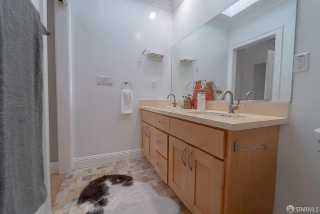 bathroom with vanity, crown molding, and a skylight