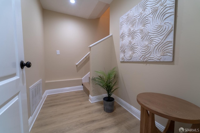 staircase with hardwood / wood-style flooring