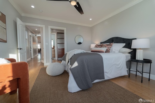 bedroom featuring hardwood / wood-style flooring, ceiling fan, and crown molding