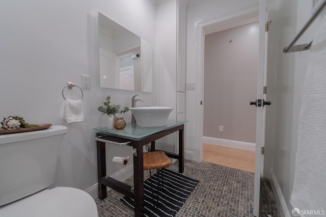 bathroom with tile patterned floors, toilet, and sink