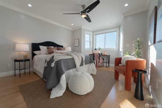 bedroom with ornamental molding, ceiling fan, and light hardwood / wood-style flooring