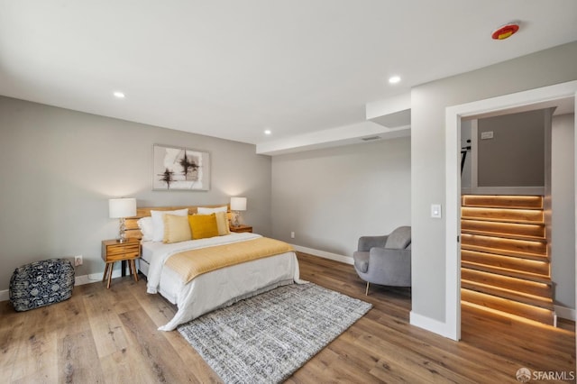 bedroom featuring recessed lighting, wood finished floors, and baseboards