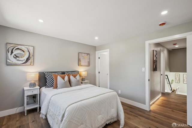bedroom featuring recessed lighting, wood finished floors, and baseboards