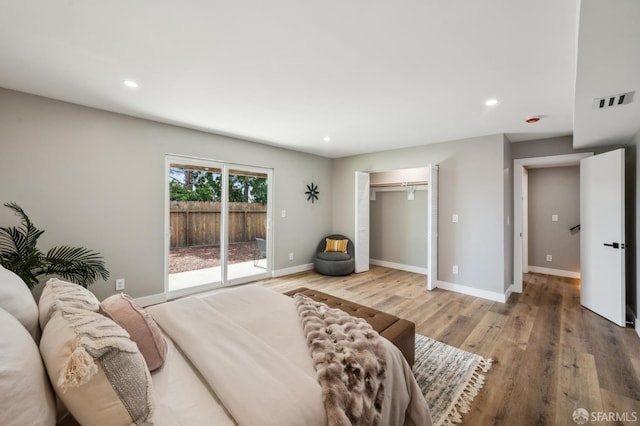 bedroom with light wood-style flooring, visible vents, baseboards, recessed lighting, and access to outside