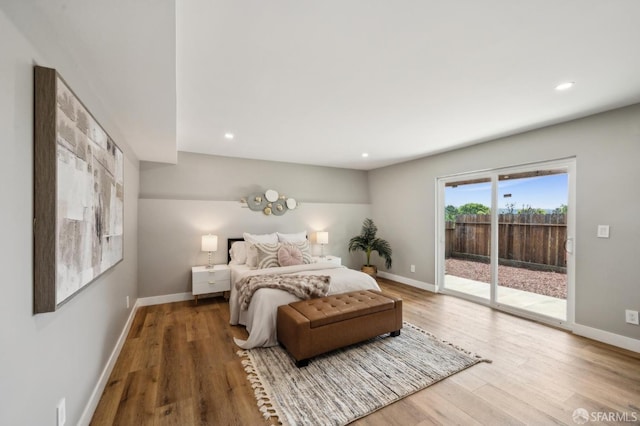 bedroom featuring recessed lighting, wood finished floors, access to exterior, and baseboards