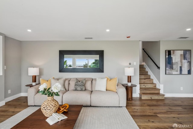 living room with wood finished floors, visible vents, recessed lighting, and stairway
