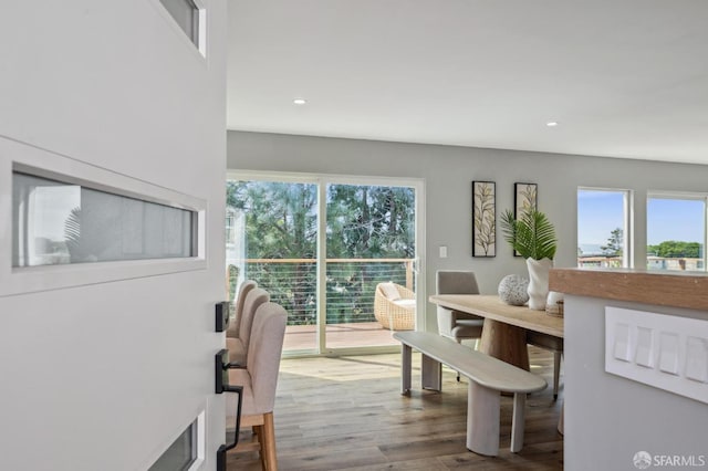dining space with recessed lighting, wood finished floors, and a healthy amount of sunlight