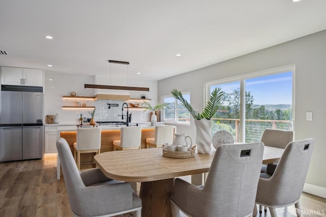 dining area featuring recessed lighting, visible vents, and light wood finished floors