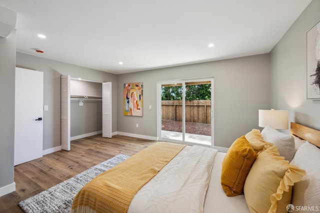 bedroom featuring access to outside, wood finished floors, and recessed lighting