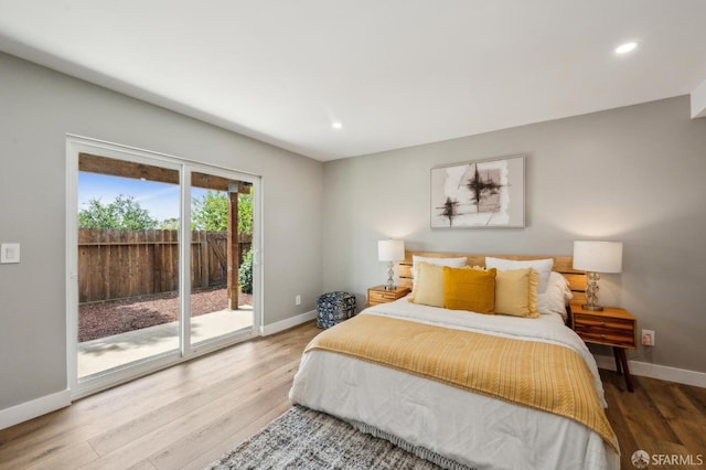 bedroom featuring baseboards, access to outside, wood finished floors, and recessed lighting