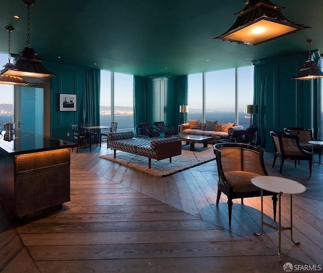 living room featuring floor to ceiling windows and hardwood / wood-style floors
