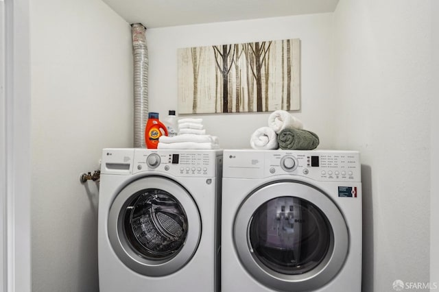 clothes washing area with independent washer and dryer