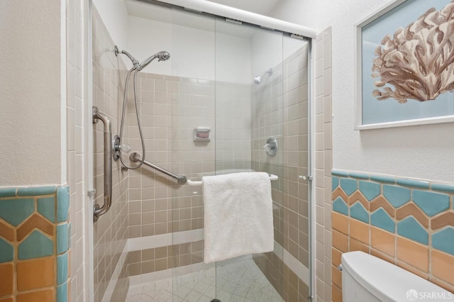 bathroom with toilet, tile walls, and an enclosed shower