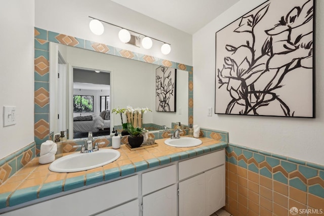 bathroom with tile walls and vanity