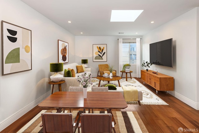 interior space with dark hardwood / wood-style flooring and a skylight