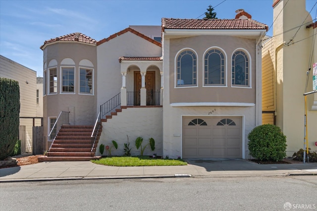 2645 14th Ave, San Francisco, CA 94127 - mediterranean / spanish house with stairs, stucco siding, an attached garage, a tile roof, and concrete driveway