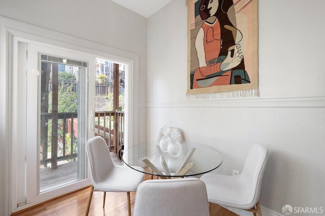 dining room featuring wood finished floors and a healthy amount of sunlight