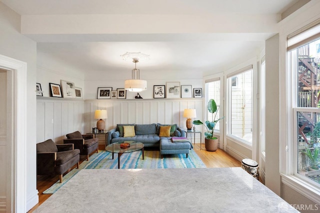 living room featuring wainscoting and light wood-style flooring