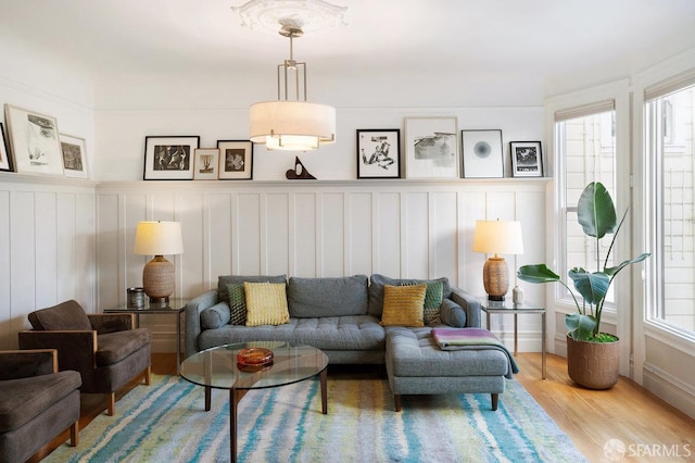 living room featuring light wood-style flooring and a healthy amount of sunlight