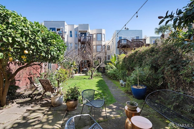 view of community featuring a yard and fence