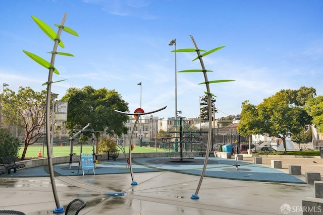 view of sport court with fence and playground community