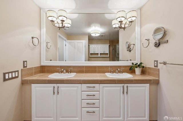 bathroom with vanity and a chandelier