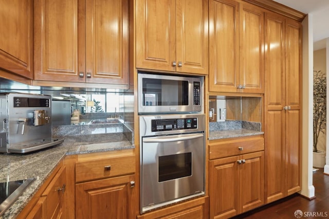 kitchen featuring appliances with stainless steel finishes, backsplash, and dark hardwood / wood-style flooring